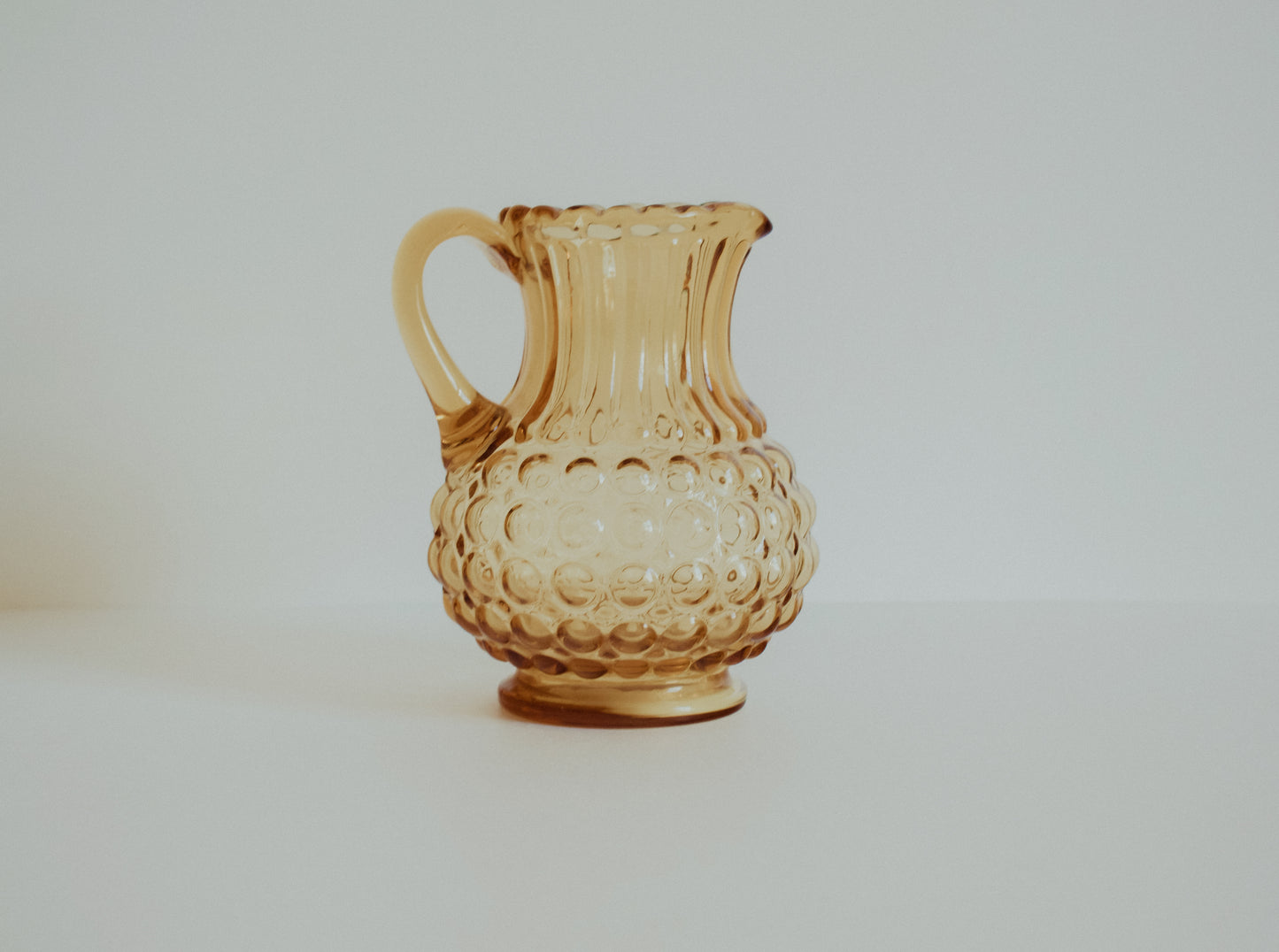 Vintage amber glass pitcher or vase